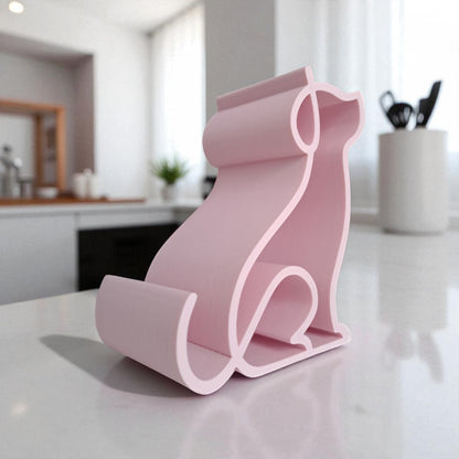 3D printed pink dog-shaped phone holder for desk, used to support a smartphone, tablet, or Kindle, ideal for pet lovers and home office decor