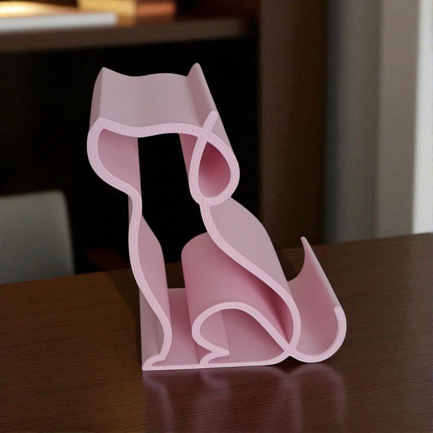 3d printed pink dog-shaped phone holder for desk, used to support a smartphone, tablet, or kindle, ideal for pet lovers and home office decor