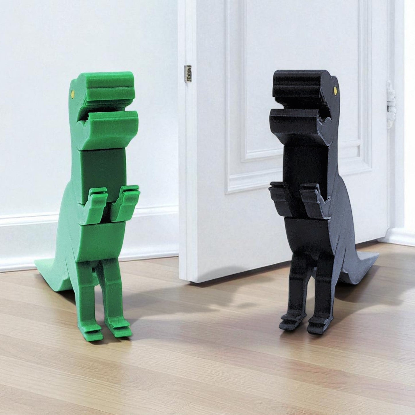 green and black dinosaur-shaped door stoppers on a wooden floor.