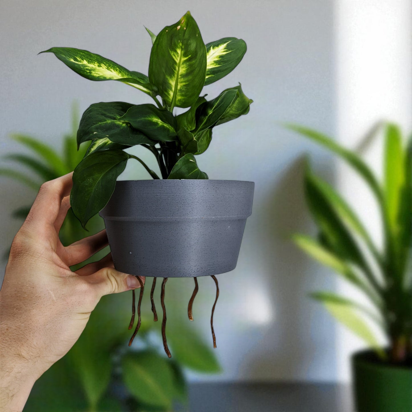 a clever and charming worm rise planter featuring a worm-shaped water indicator that rises to signal when the plant has enough water. perfect for plant lovers who value functionality and fun design