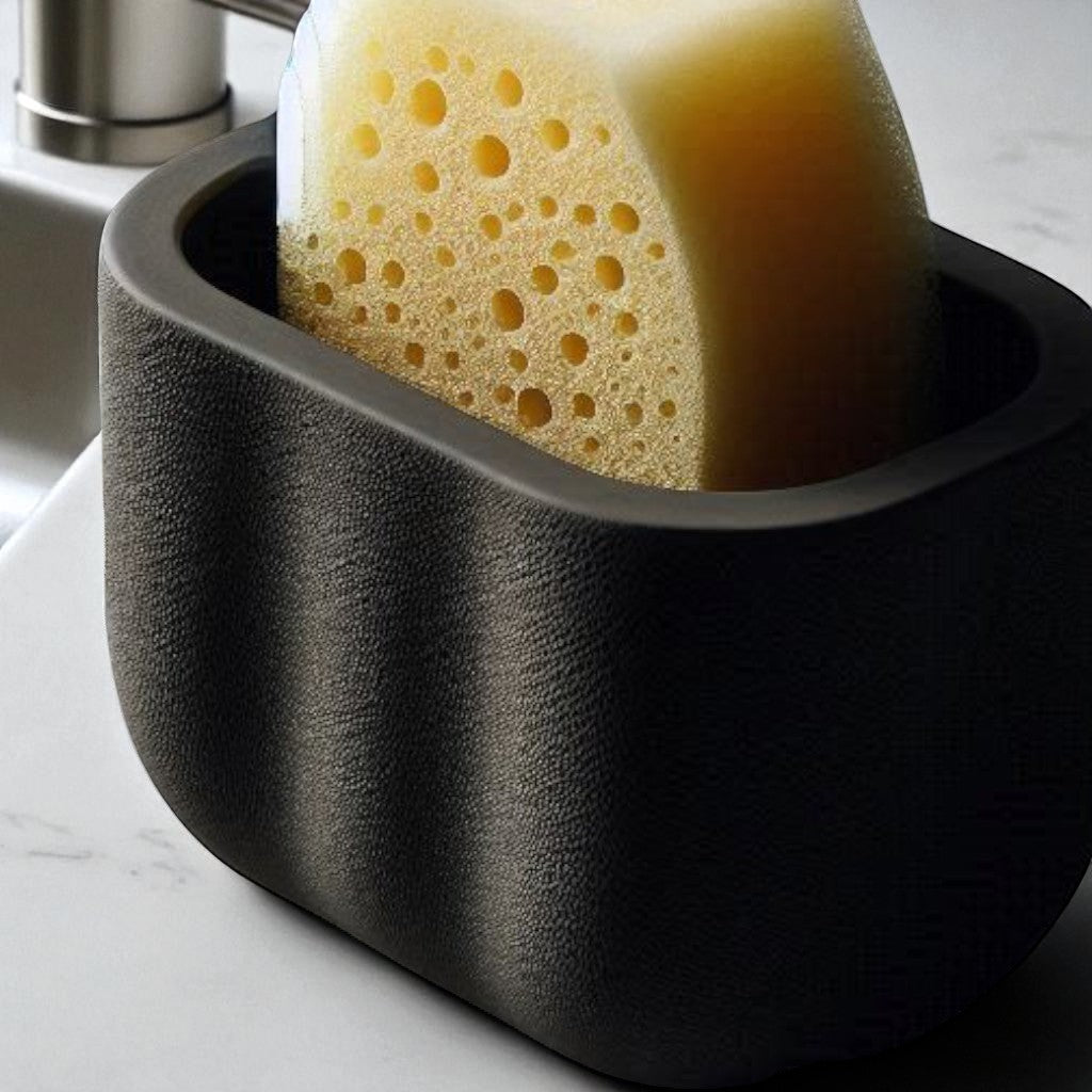 black sponge holder with a yellow sponge on a kitchen counter