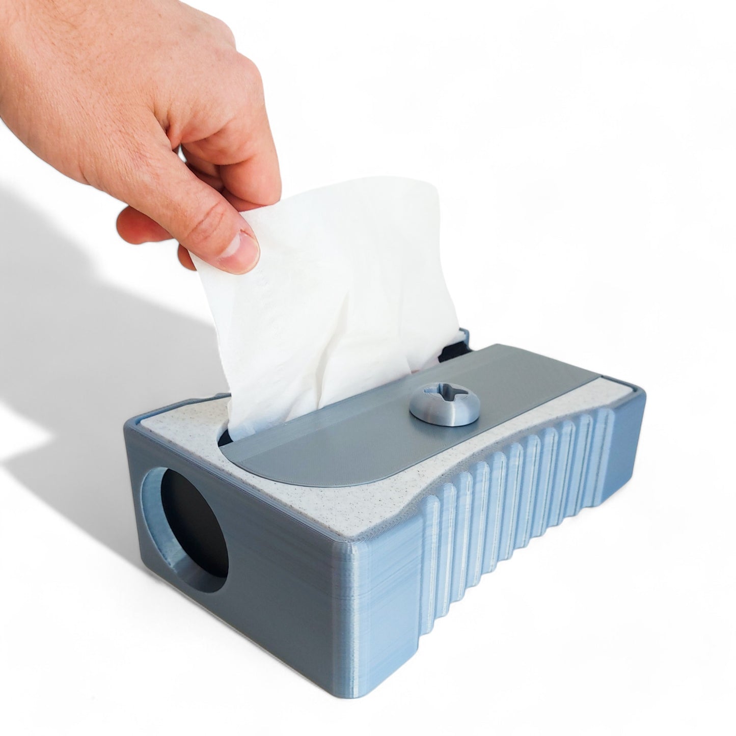 sharpener tissue box cover designed to resemble a classic pencil sharpener, made from durable 3d-printed material. fits standard tissue boxes, combining functionality with a quirky and creative design. perfect for home, office, or classroom decor