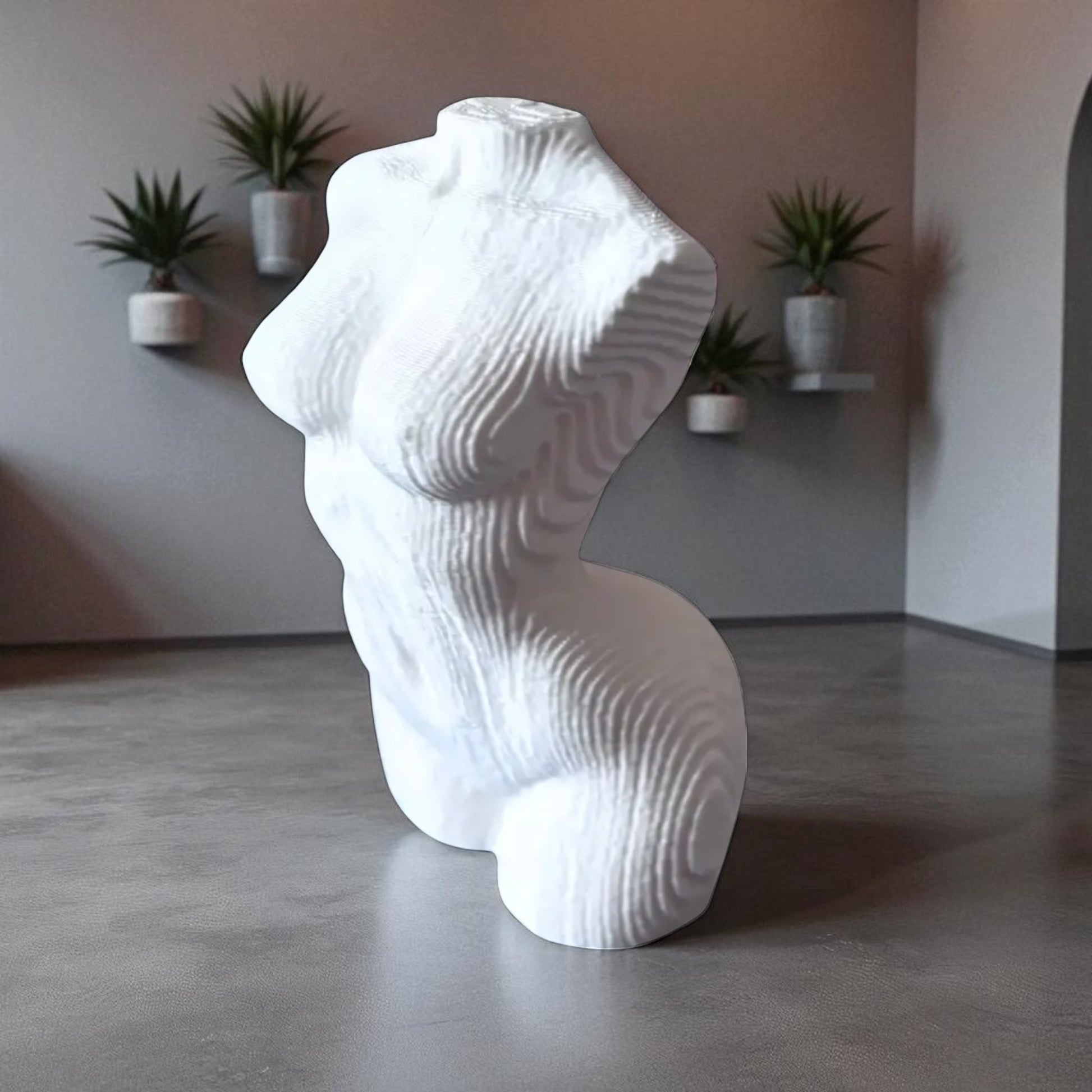 White abstract sculpture in a room with plants