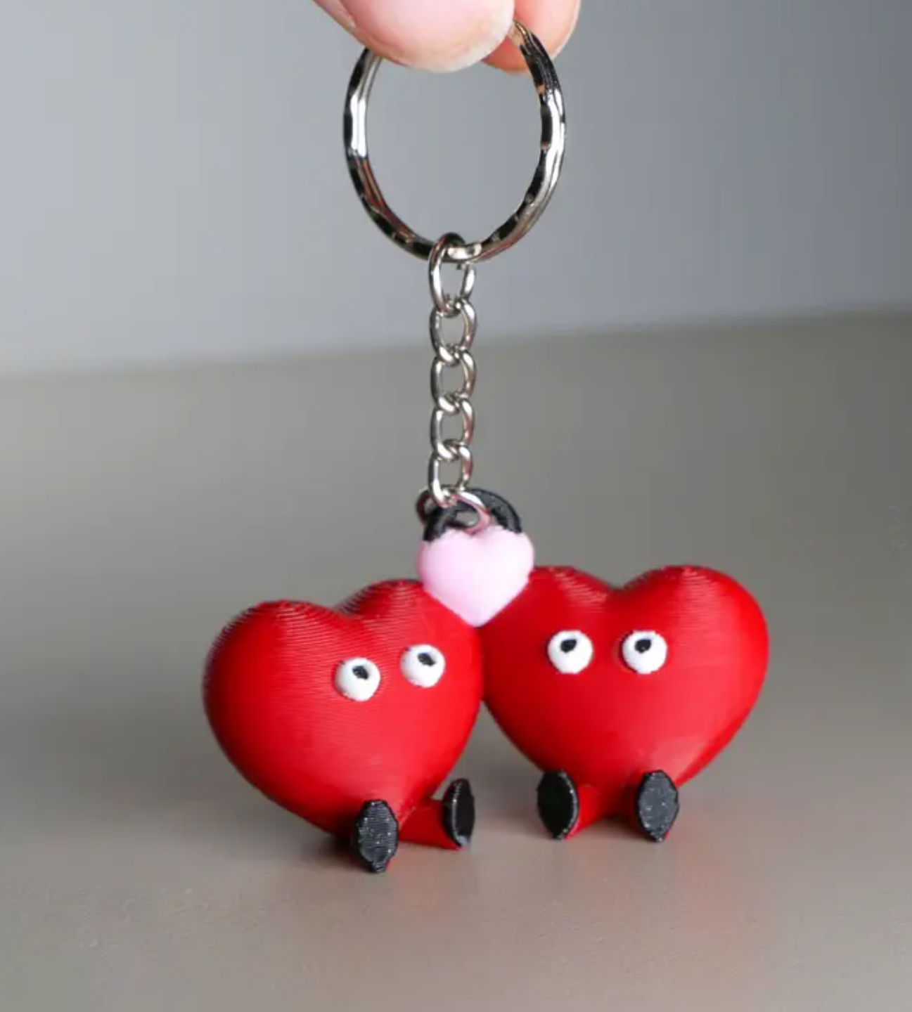 couples keychain with two hearts, feet, and eyes
