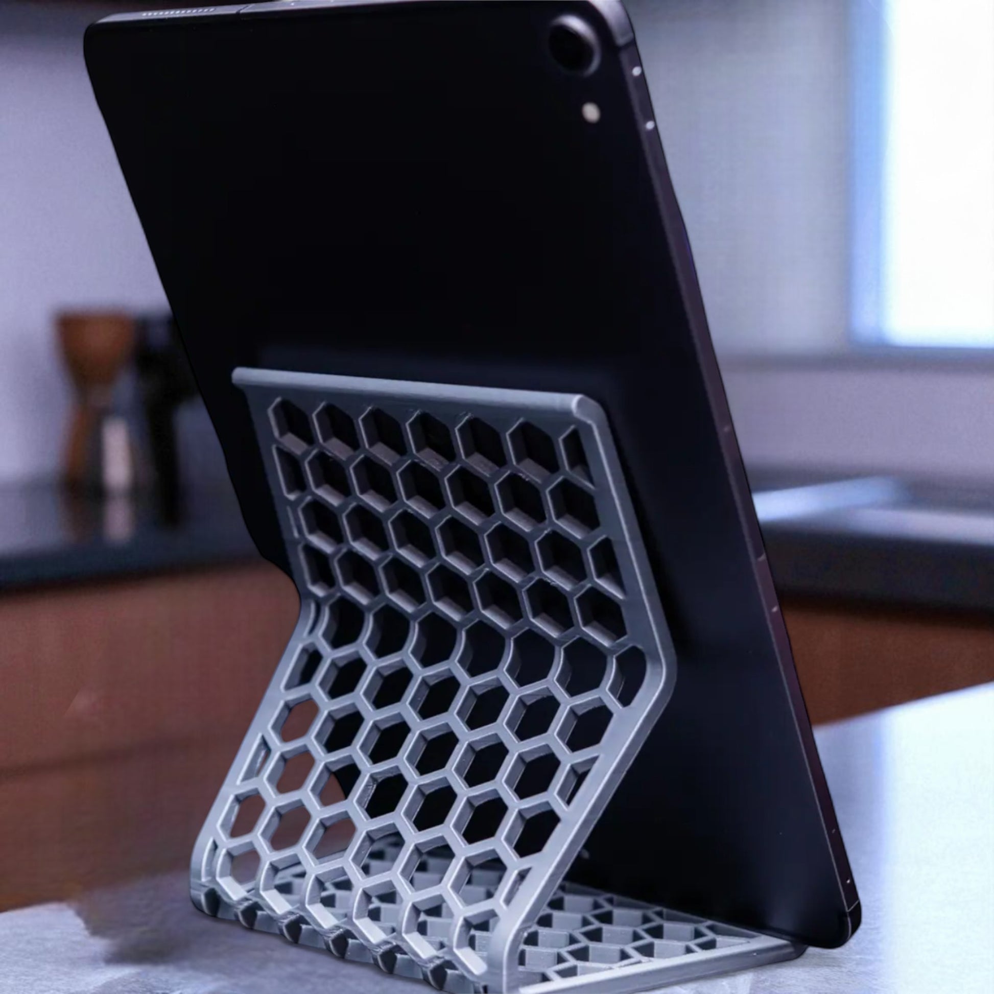 Honeycomb Stand: A versatile and stylish stand with a honeycomb pattern, designed to hold phones, tablets, and Kindles securely at an optimal viewing angle, blending functionality with modern design.