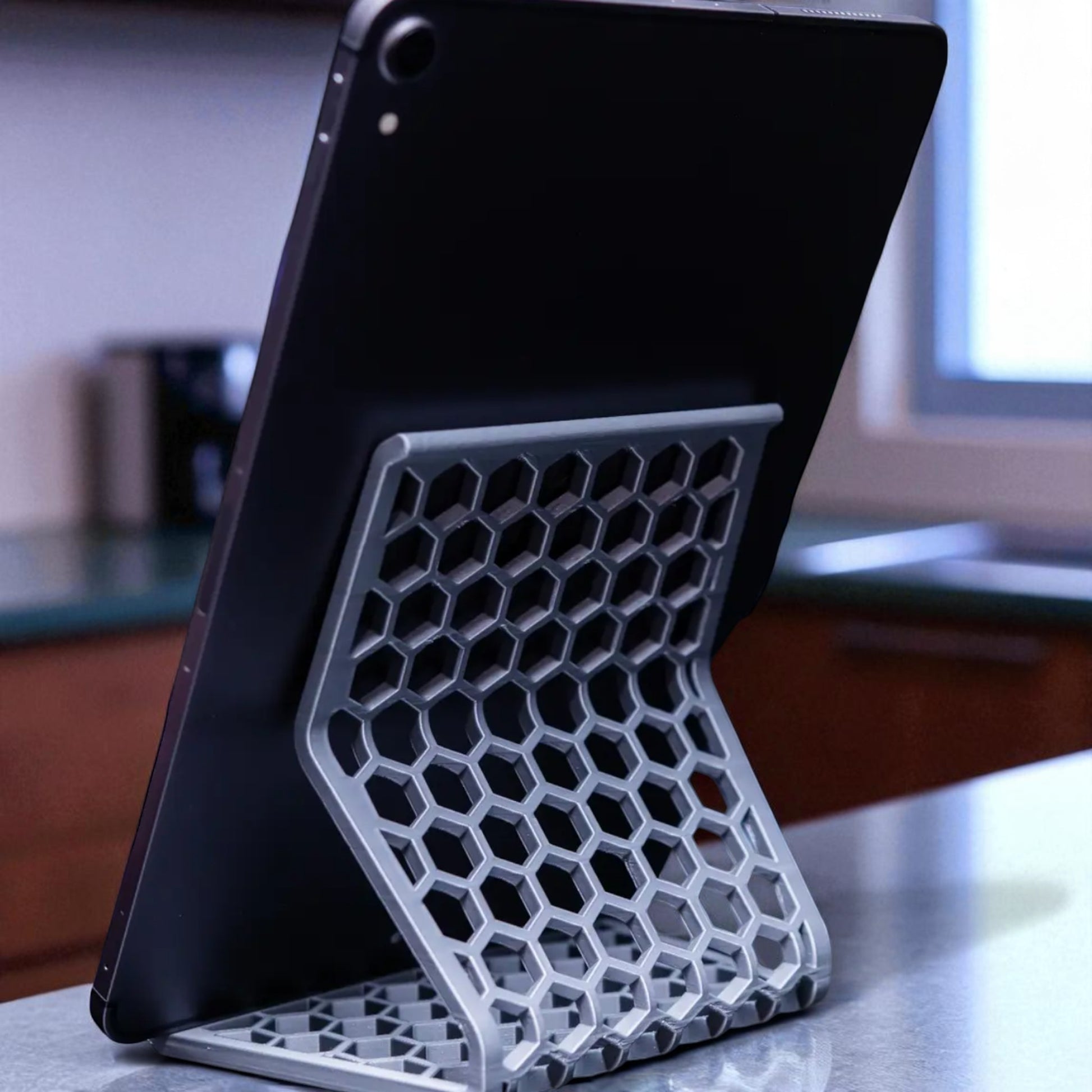 Honeycomb Stand: A versatile and stylish stand with a honeycomb pattern, designed to hold phones, tablets, and Kindles securely at an optimal viewing angle, blending functionality with modern design.