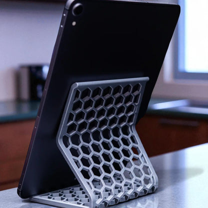 Honeycomb Stand: A versatile and stylish stand with a honeycomb pattern, designed to hold phones, tablets, and Kindles securely at an optimal viewing angle, blending functionality with modern design.