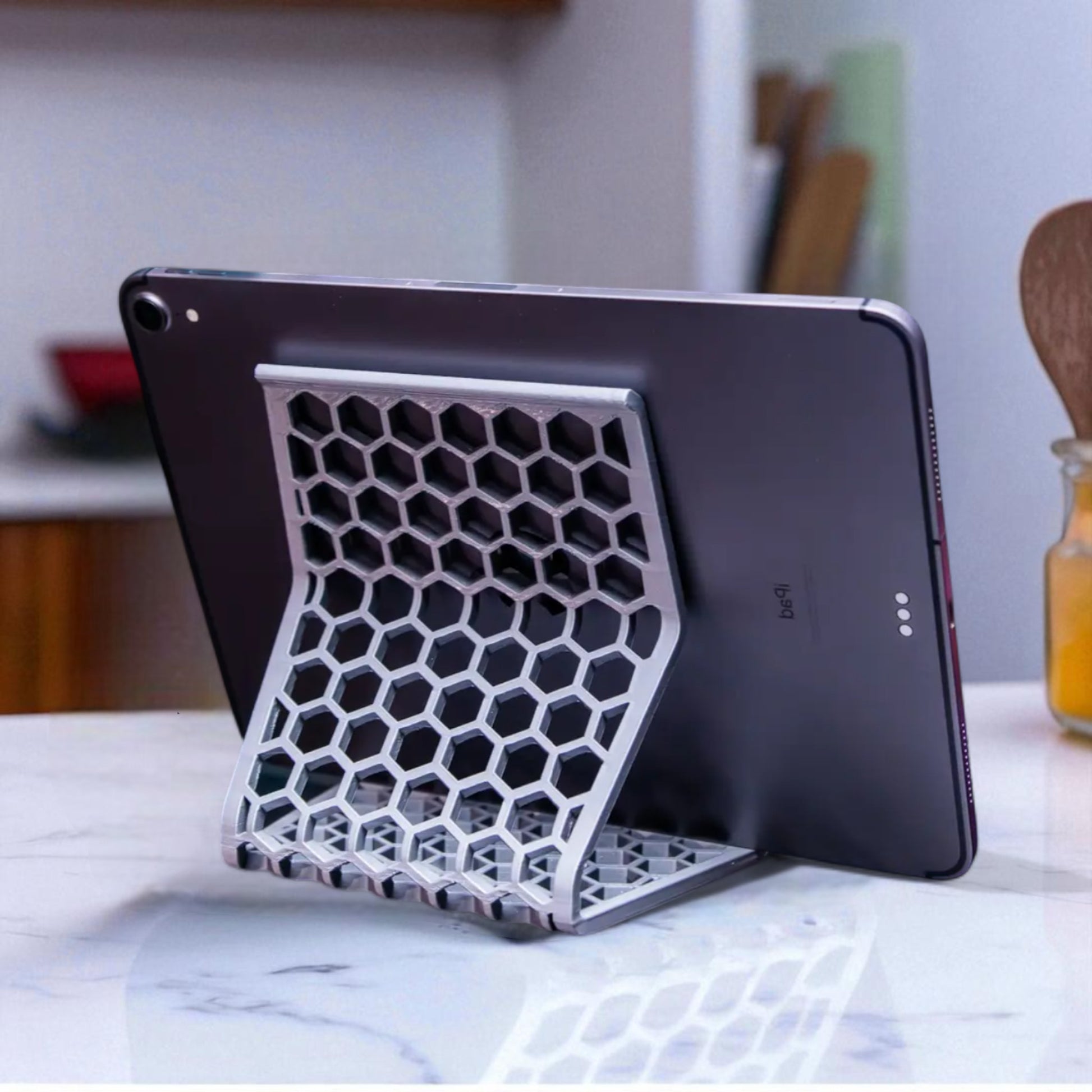 Honeycomb Stand: A versatile and stylish stand with a honeycomb pattern, designed to hold phones, tablets, and Kindles securely at an optimal viewing angle, blending functionality with modern design.