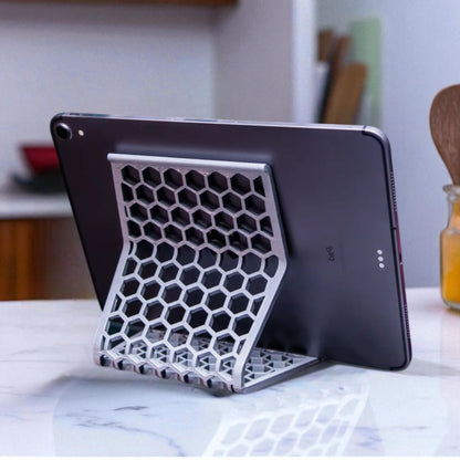 Honeycomb Stand: A versatile and stylish stand with a honeycomb pattern, designed to hold phones, tablets, and Kindles securely at an optimal viewing angle, blending functionality with modern design.