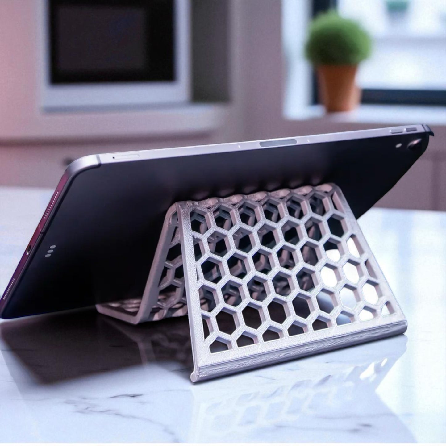 honeycomb stand: a versatile and stylish stand with a honeycomb pattern, designed to hold phones, tablets, and kindles securely at an optimal viewing angle, blending functionality with modern design.