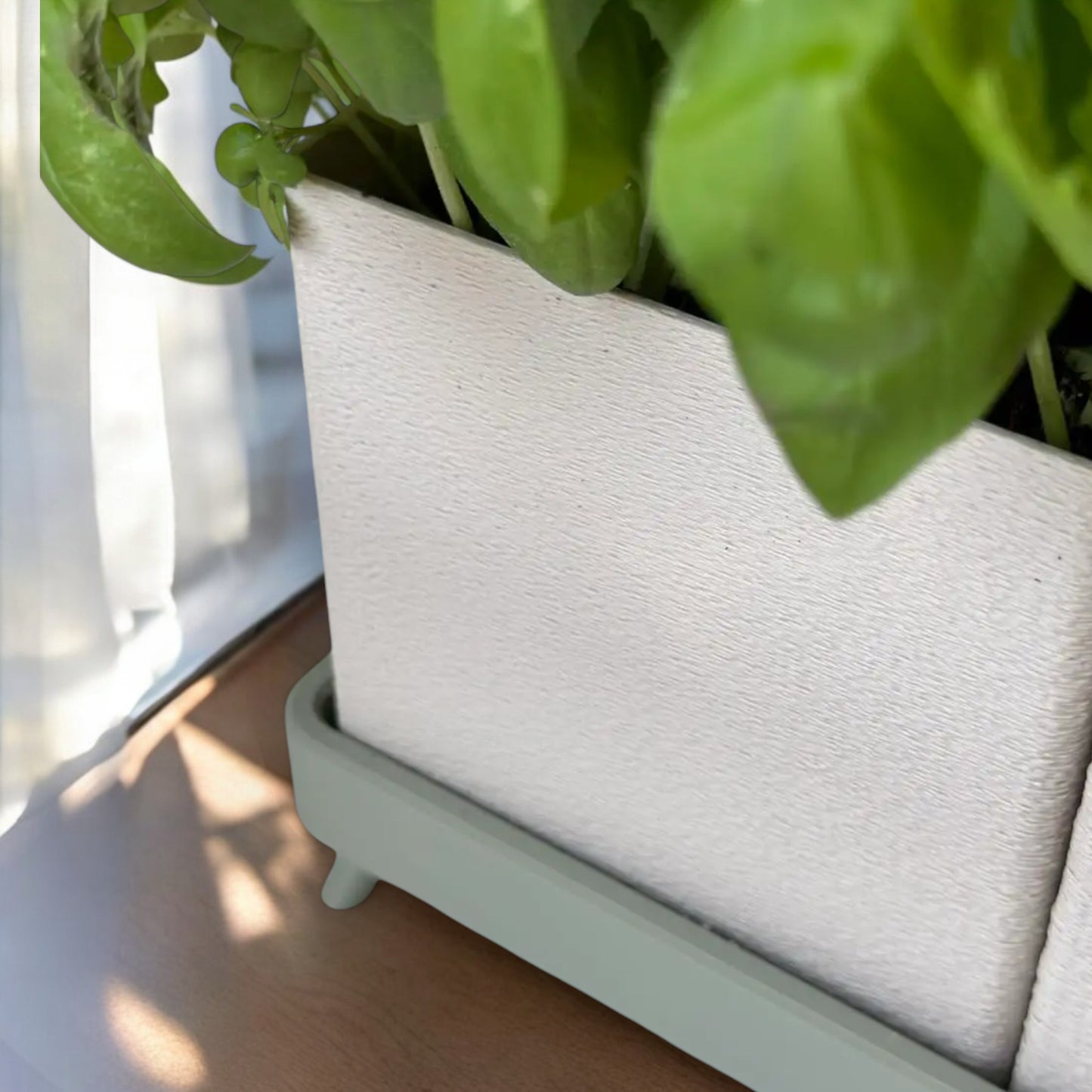 planter a versatile planter available in a single-piece design with a tray or a twin planter set with a shared tray, both featuring trays with raised feet for stability and style, perfect for growing herbs indoors or outdoors.