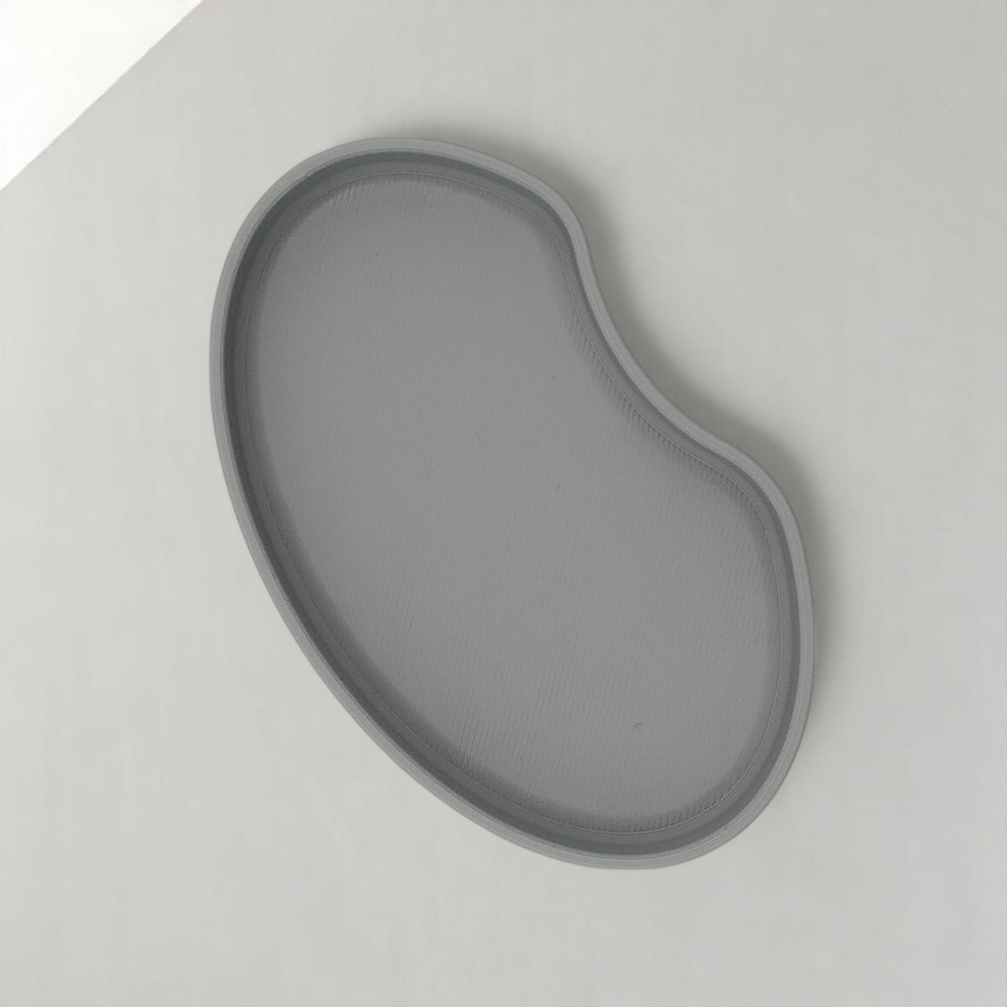 set of two bean shaped desk organizers in different sizes for tidy and stylish storage.