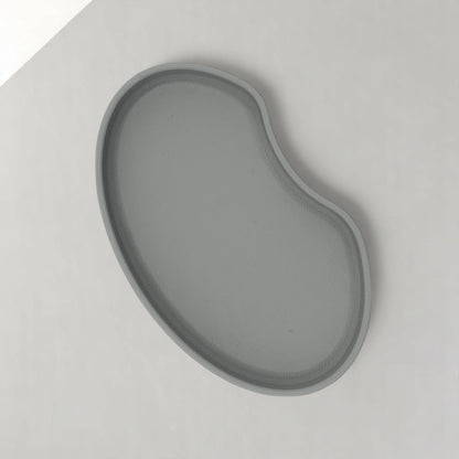 Set of two bean shaped desk organizers in different sizes for tidy and stylish storage.