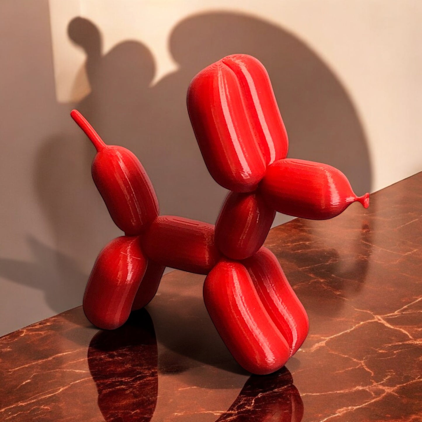 3d-printed figurine resembling a playful dog made from balloons, available in three different sizes. perfect for home decor, kids' rooms, or as a unique gift for dog lovers.