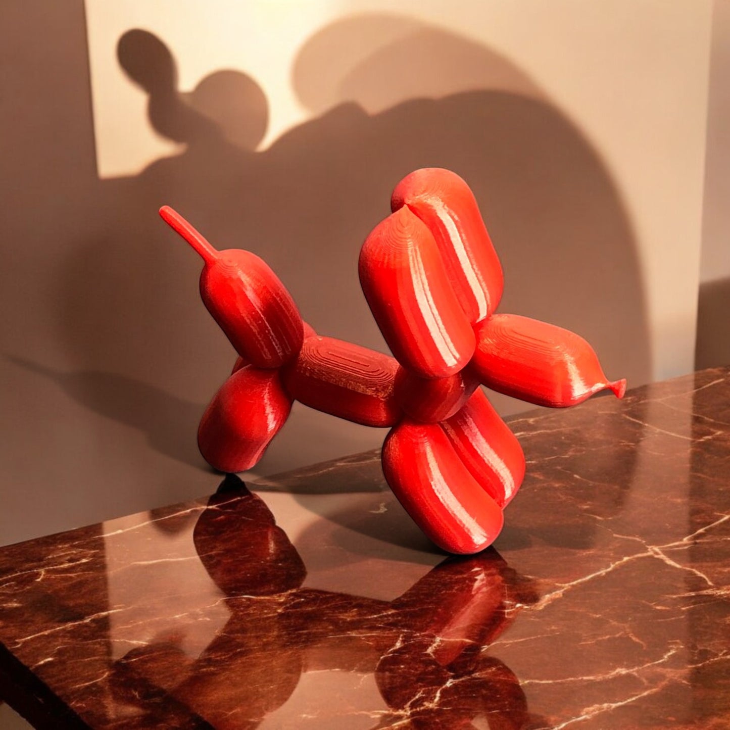 3d-printed figurine resembling a playful dog made from balloons, available in three different sizes. perfect for home decor, kids' rooms, or as a unique gift for dog lovers.