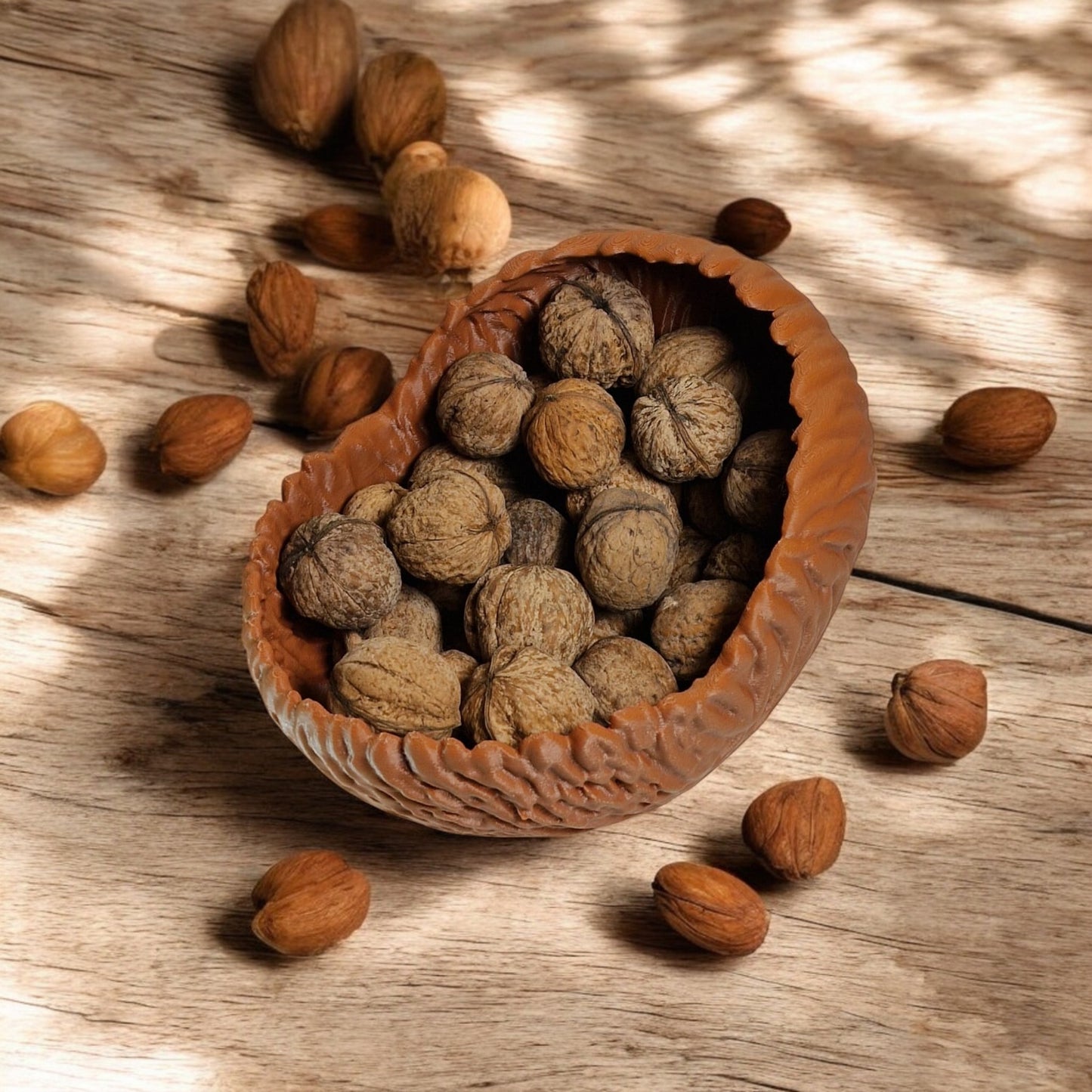 a beautifully designed walnut-shaped bowl resembling a quarter of a walnut shell, perfect as a key tray, candy dish, or nut bowl. features a rustic, nature-inspired design with a smooth finish, making it a stylish and functional home décor piece.