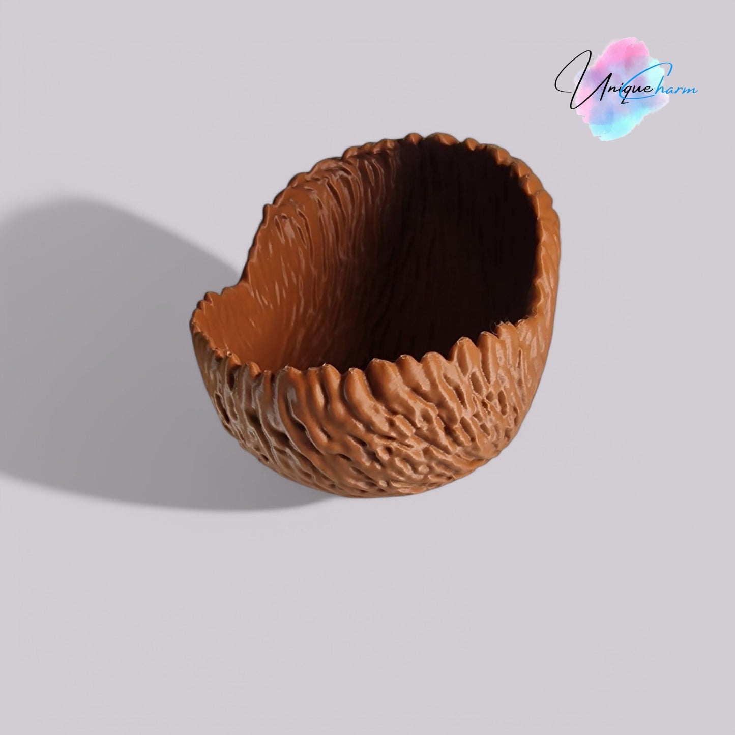 a beautifully designed walnut-shaped bowl resembling a quarter of a walnut shell, perfect as a key tray, candy dish, or nut bowl. features a rustic, nature-inspired design with a smooth finish, making it a stylish and functional home décor piece.