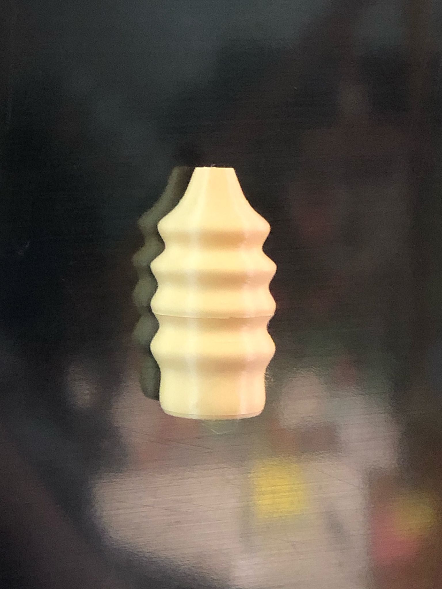 Set of 5 small magnetic mini vases in random earthy brown tones, 3D printed with a modern design, displayed on a fridge holding tiny flowers.

