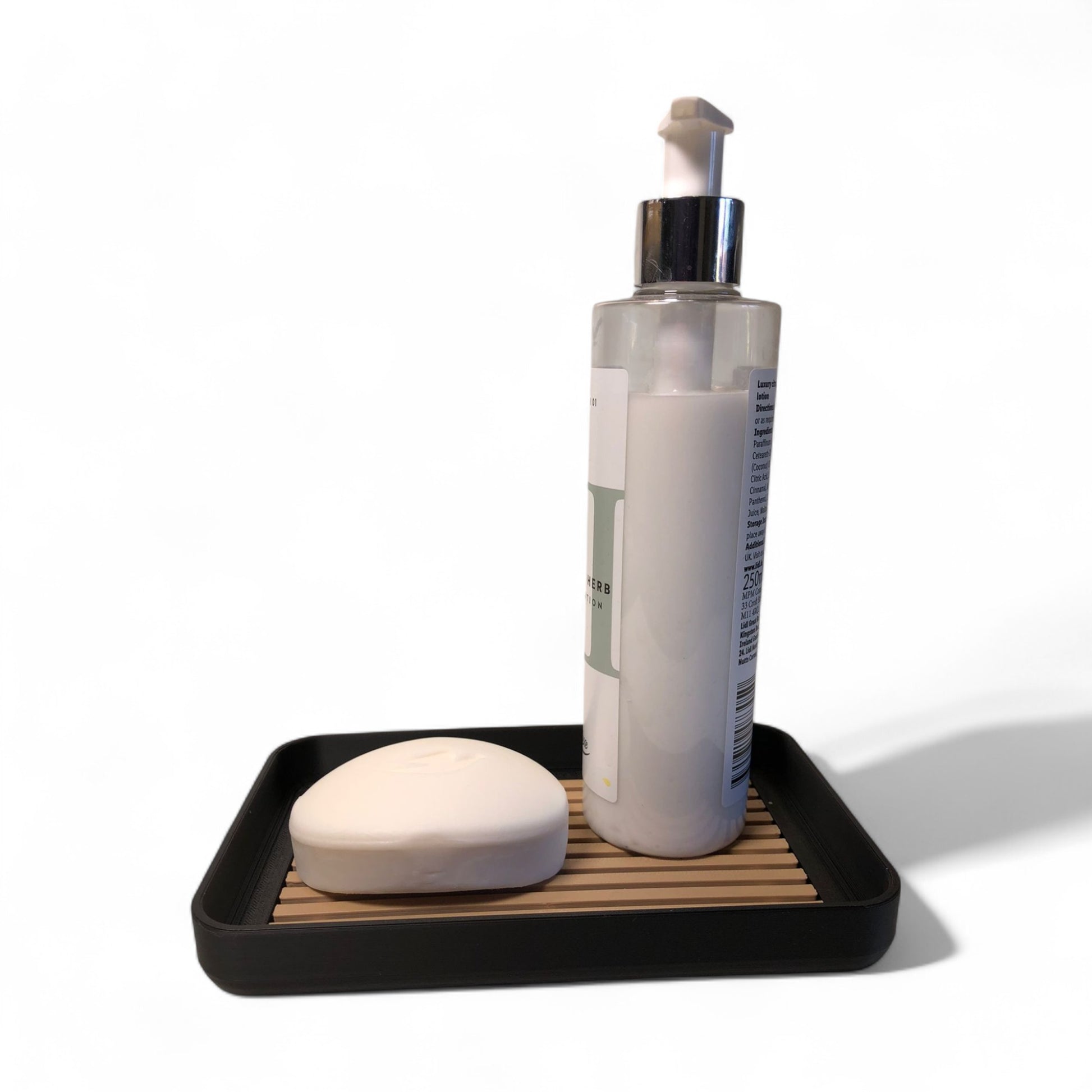 Modern soap tray with raised drainage support, shown holding a soap bar and pump bottle, perfect for bathroom organization and keeping soap dry

