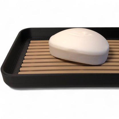 Modern soap tray with raised drainage support, shown holding a soap bar and pump bottle, perfect for bathroom organization and keeping soap dry

