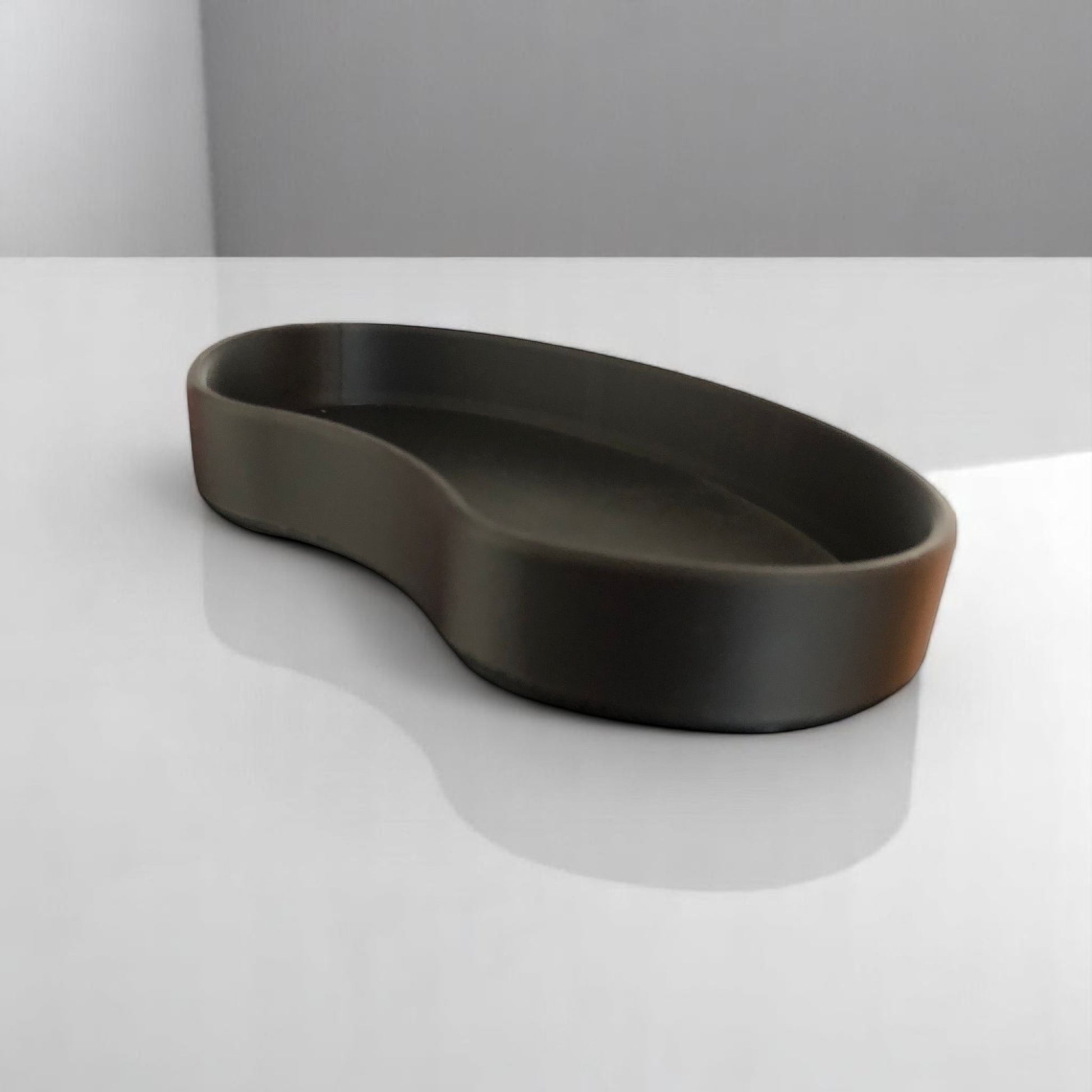 Set of two bean shaped desk organizers in different sizes for tidy and stylish storage.