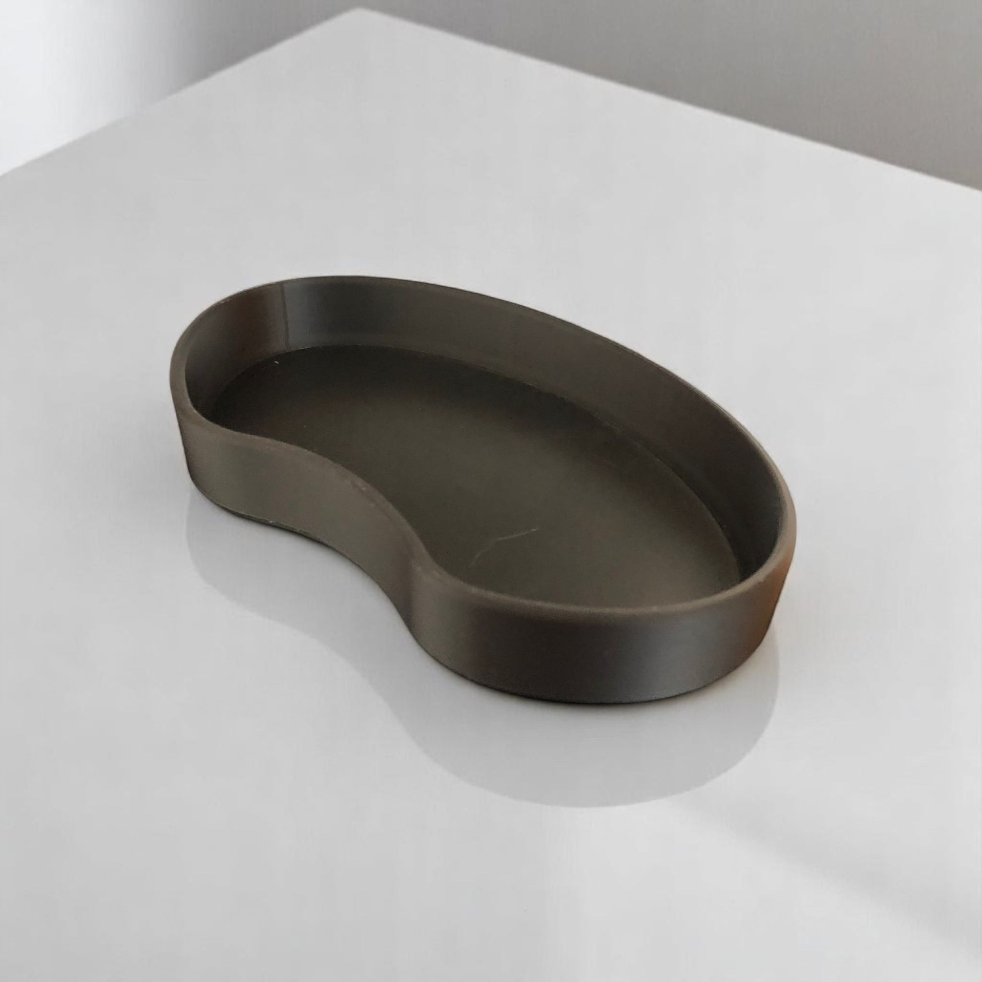 Set of two bean shaped desk organizers in different sizes for tidy and stylish storage.