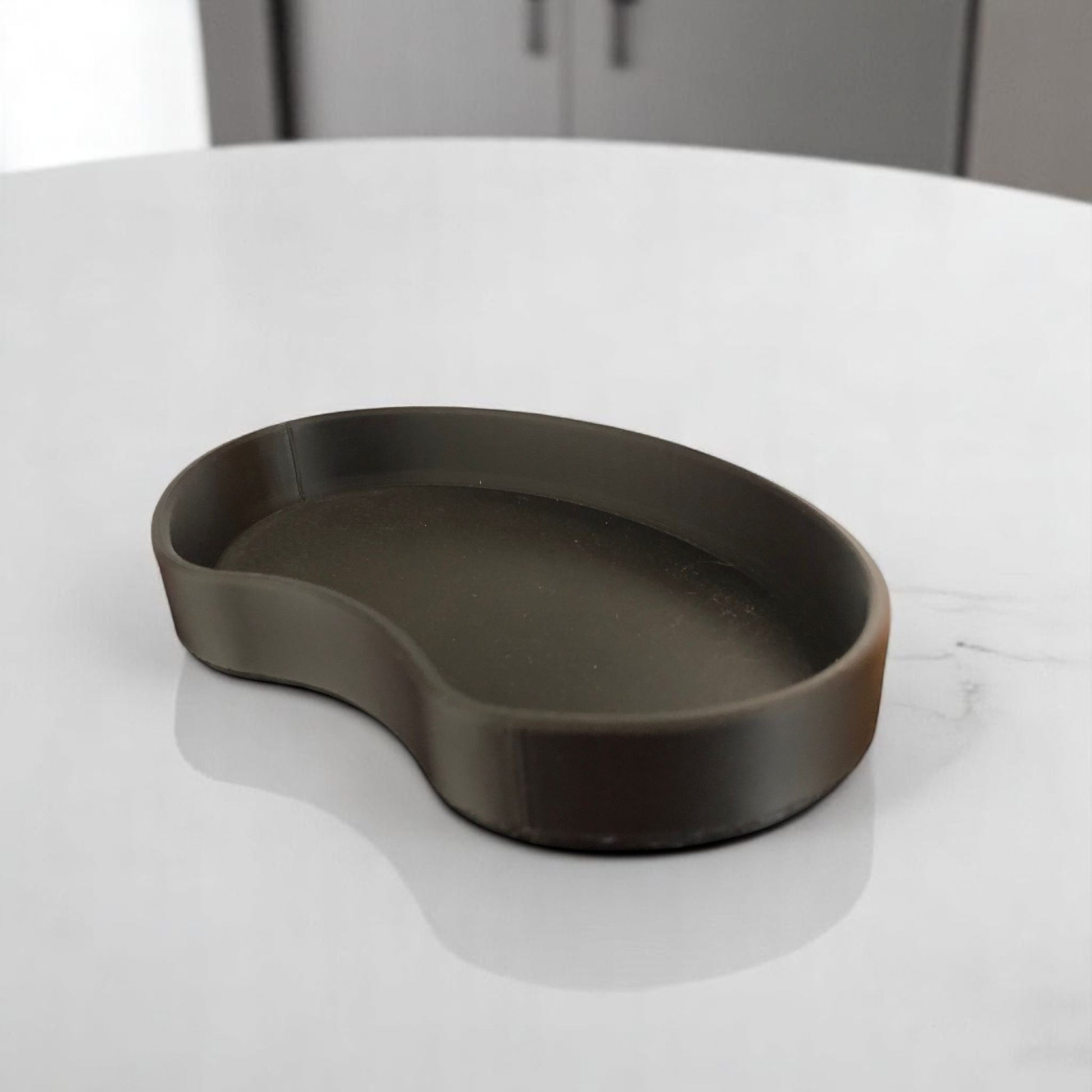 Set of two bean shaped desk organizers in different sizes for tidy and stylish storage.