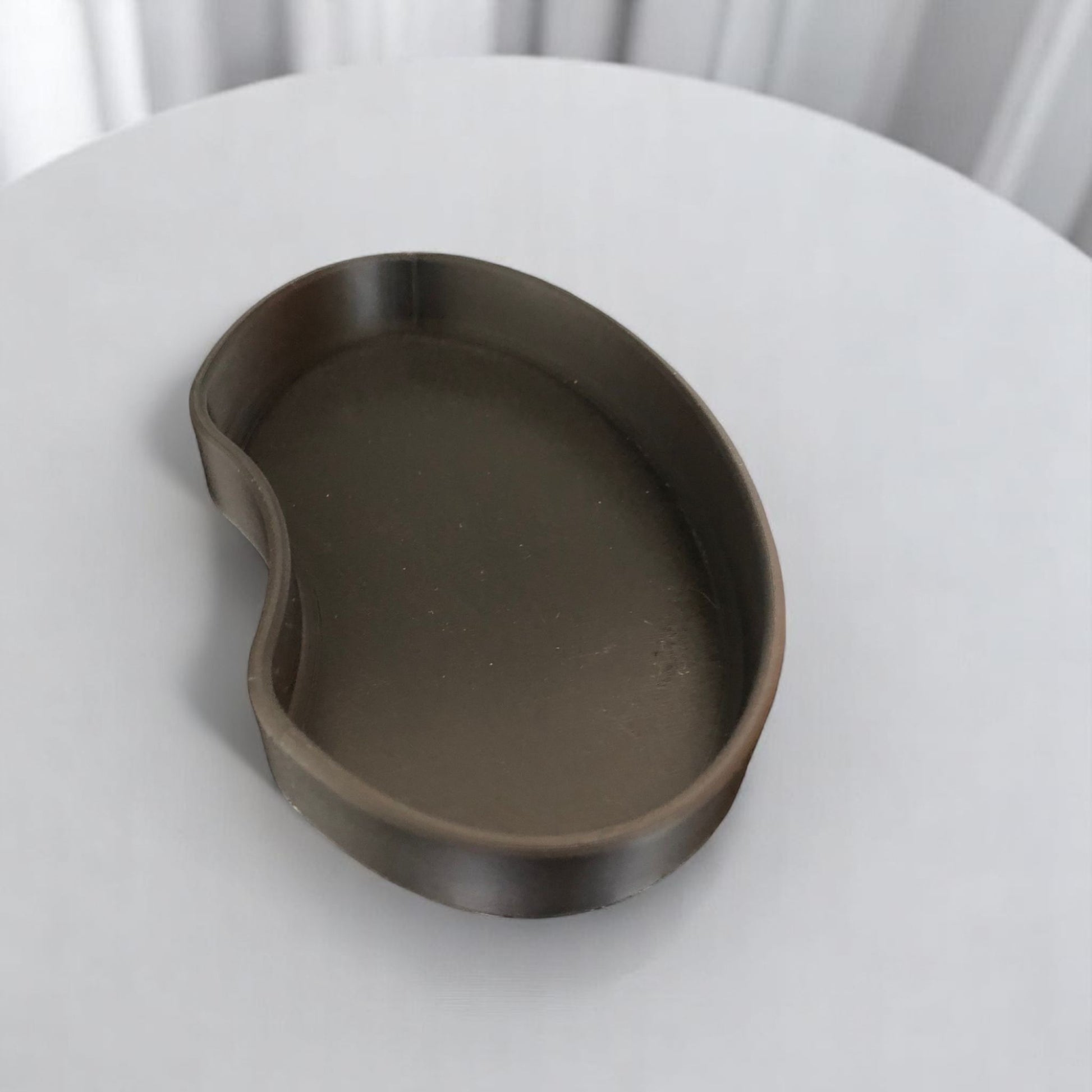 Set of two bean shaped desk organizers in different sizes for tidy and stylish storage.
