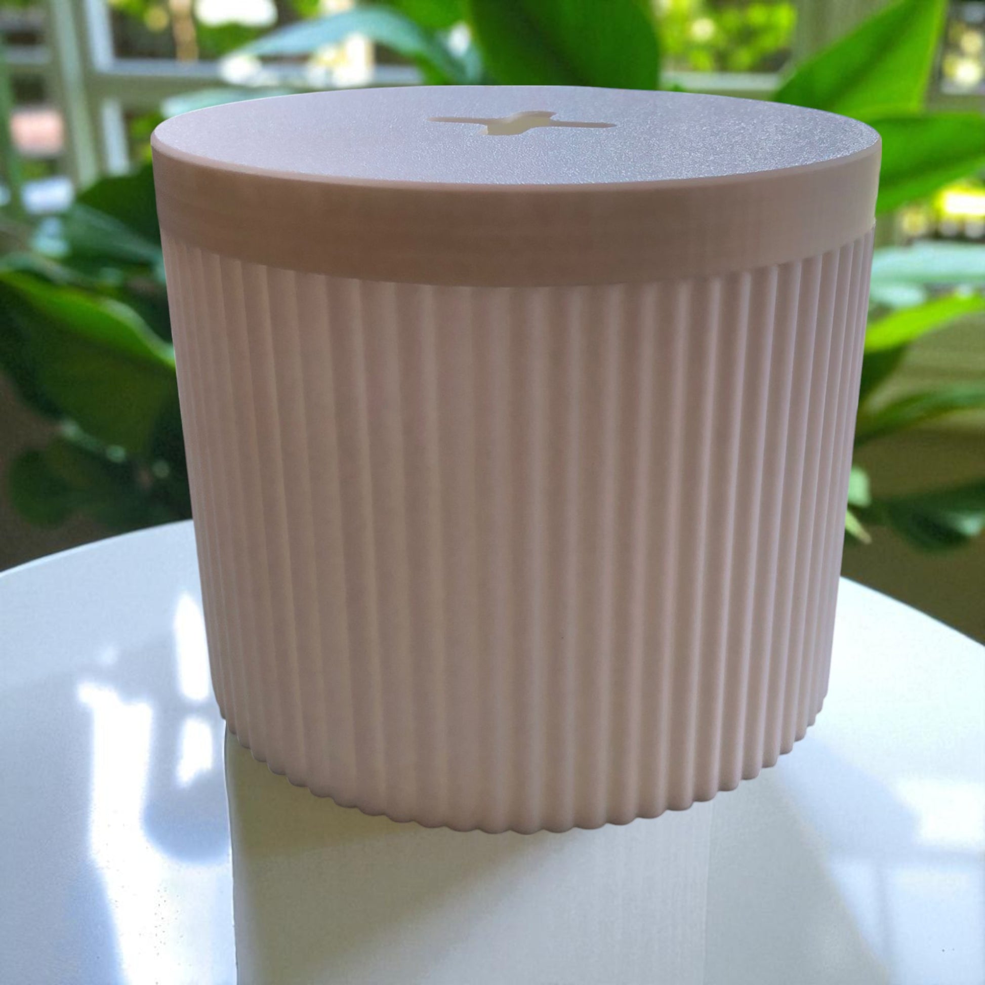 A stylish and practical toilet paper holder box designed to fit a whole roll, keeping it safe from kids and pets. Features a small opening for easy access while maintaining a clean and organized look.