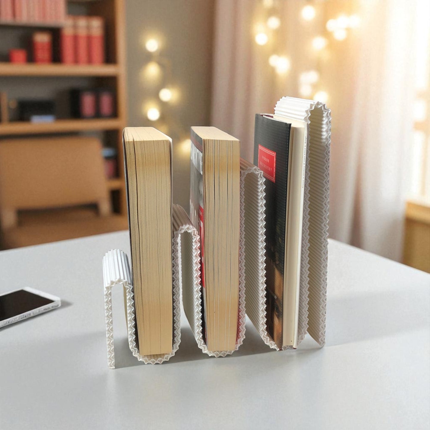 modern wavy book stand in textured white, holding two books upright; perfect for organizing books, magazines, or vinyls on a desk, shelf, or reading nook