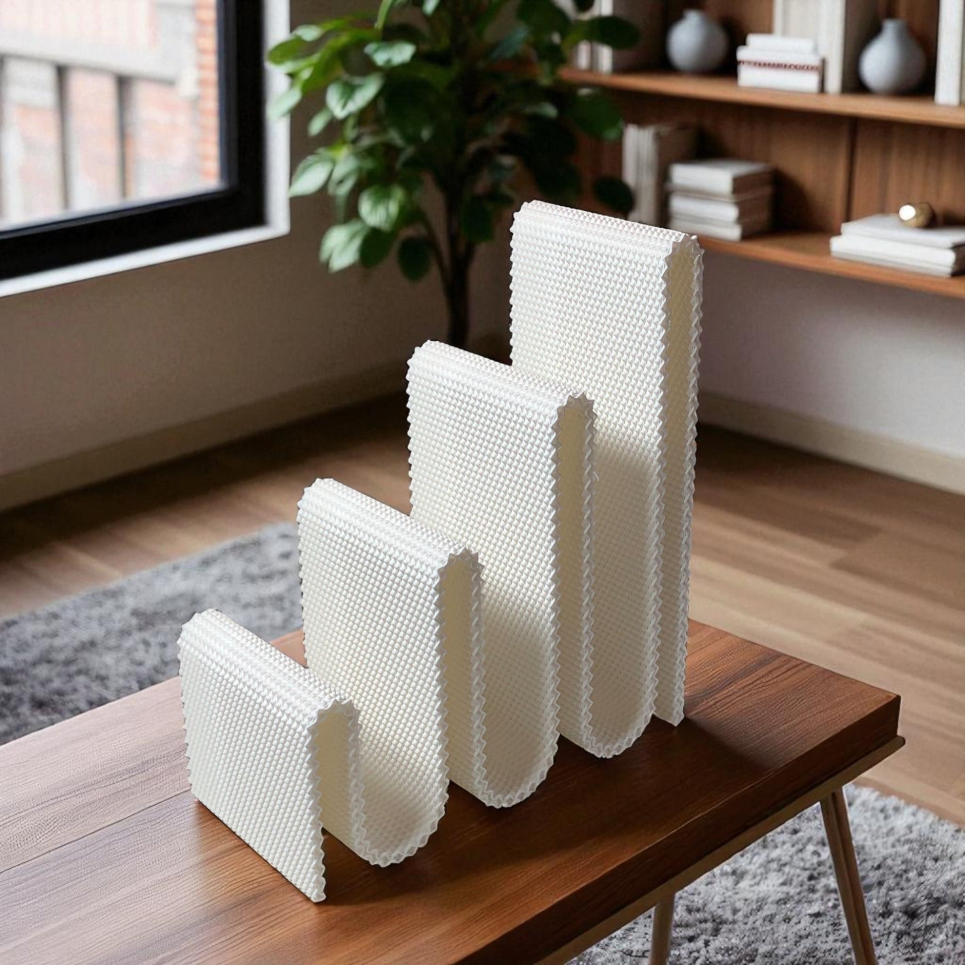 Modern wavy book stand in textured white, holding two books upright; perfect for organizing books, magazines, or vinyls on a desk, shelf, or reading nook