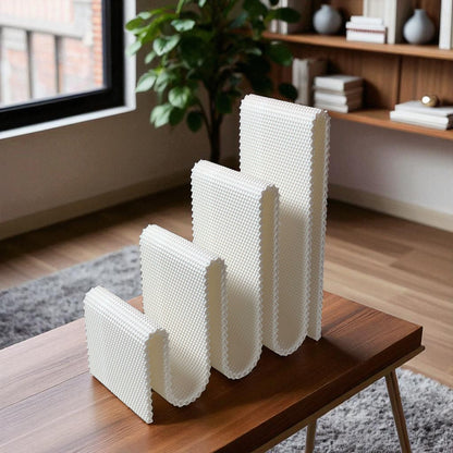 Modern wavy book stand in textured white, holding two books upright; perfect for organizing books, magazines, or vinyls on a desk, shelf, or reading nook