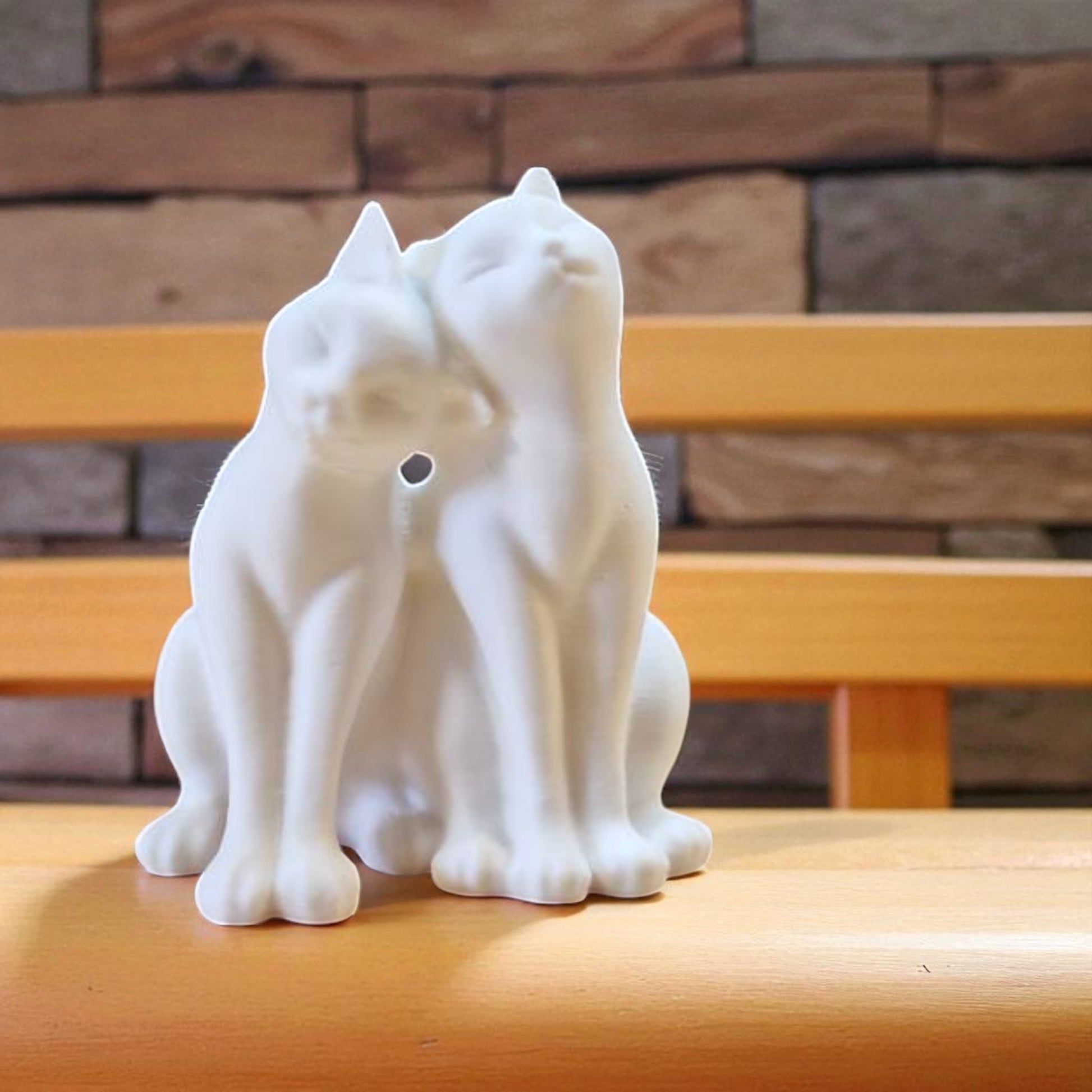 A heartwarming statue of two cats, symbolizing love and companionship between animals. Perfect for cat lovers and a charming addition to any home decor.