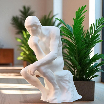 A statue titled 'Contemplative Reflection' depicting a man seated in a thoughtful, meditative pose. This sculpture embodies the essence of mindfulness, yoga, and inner peace, symbolizing the journey of reflection and self-discovery