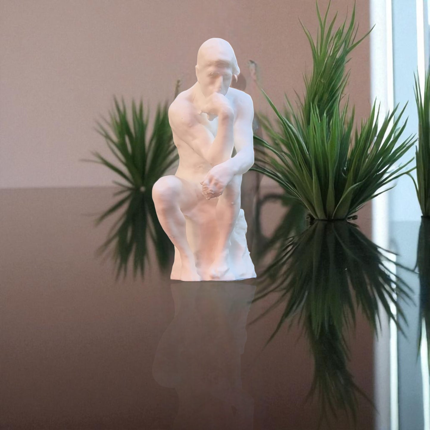 a statue titled 'contemplative reflection' depicting a man seated in a thoughtful, meditative pose. this sculpture embodies the essence of mindfulness, yoga, and inner peace, symbolizing the journey of reflection and self-discovery