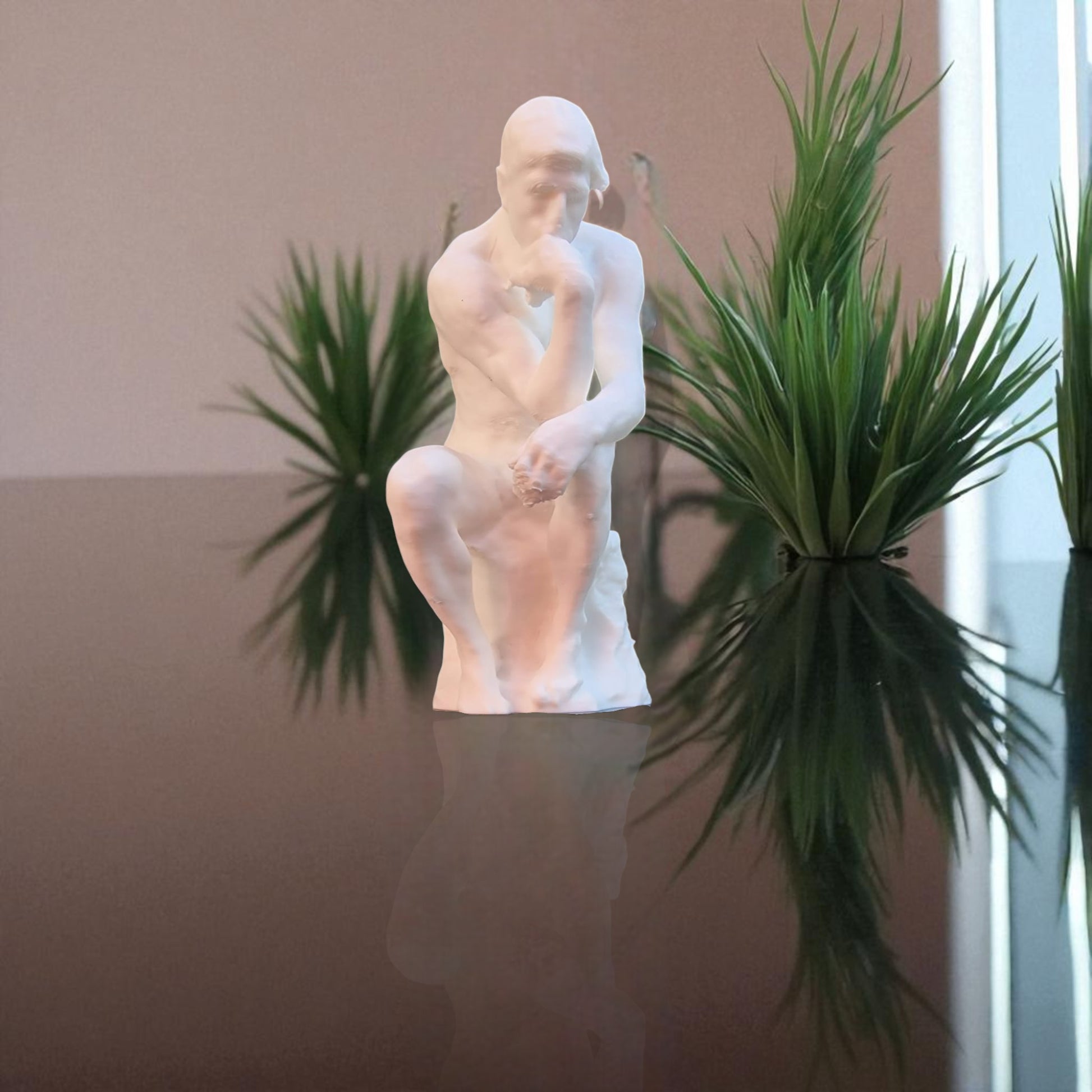 A statue titled 'Contemplative Reflection' depicting a man seated in a thoughtful, meditative pose. This sculpture embodies the essence of mindfulness, yoga, and inner peace, symbolizing the journey of reflection and self-discovery