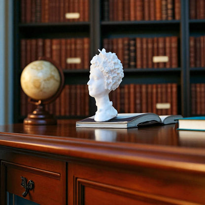Stunning 'Flora Grace Sculpture,' a statue of an Egyptian-inspired lady resembling Aphrodite, adorned with intricate flowers and butterflies in her hair. This elegant piece exudes beauty and sophistication, making it a timeless decorative accent.
