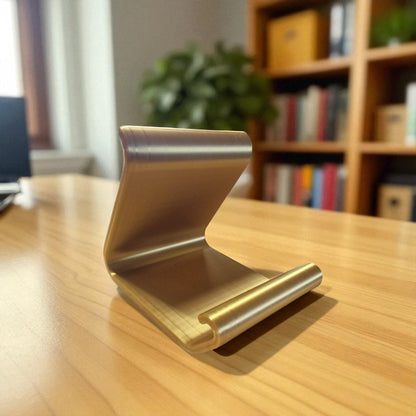 Ergonomic phone holder made of durable 3D-printed material, designed with a sleek and modern look. It securely holds your phone at an optimal angle for comfortable viewing, making it perfect for desks, nightstands, or kitchen counters. Compact, stylish, and practical for everyday use