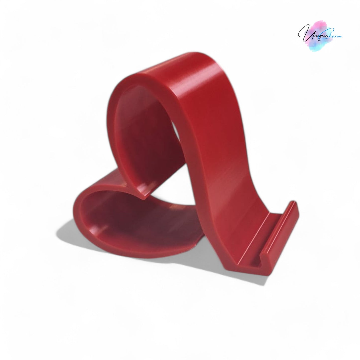 heart-shaped universal phone and kindle holder in an elegant design, securely holding a smartphone on a desk. stylish and versatile stand suitable for all phones, kindles, and small tablets, perfect for hands-free viewing