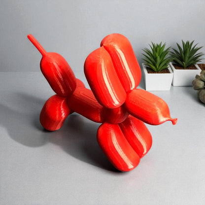 3D-printed figurine resembling a playful dog made from balloons, available in three different sizes. Perfect for home decor, kids' rooms, or as a unique gift for dog lovers.
