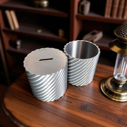 A modern spiral coin bank with a unique closing mechanism. Features a sleek, minimalist design where coins drop smoothly into the bank, and the lid twists shut in a mesmerizing spiral motion. Perfect for stylish and satisfying money-saving!