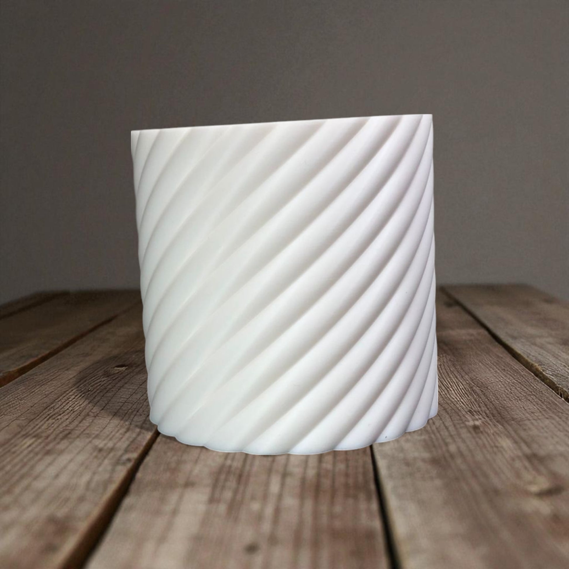 A modern spiral coin bank with a unique closing mechanism. Features a sleek, minimalist design where coins drop smoothly into the bank, and the lid twists shut in a mesmerizing spiral motion. Perfect for stylish and satisfying money-saving!