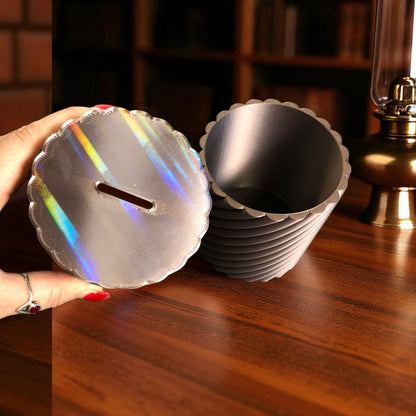A modern spiral coin bank with a unique closing mechanism. Features a sleek, minimalist design where coins drop smoothly into the bank, and the lid twists shut in a mesmerizing spiral motion. Perfect for stylish and satisfying money-saving!