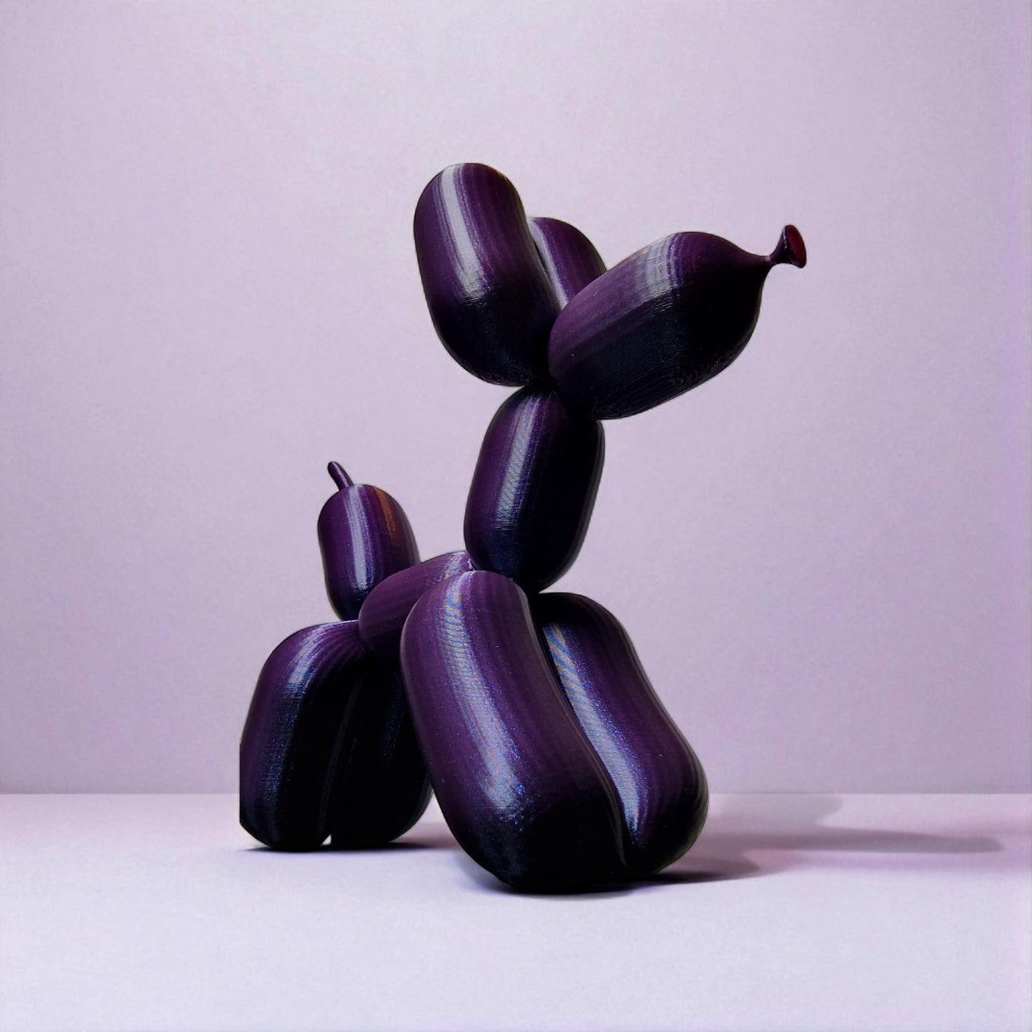 3d-printed figurine resembling a playful dog made from balloons, available in three different sizes. perfect for home decor, kids' rooms, or as a unique gift for dog lovers.