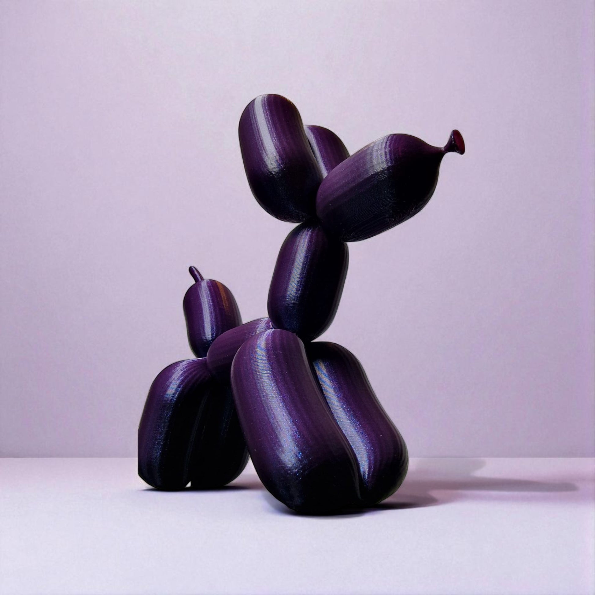 3D-printed figurine resembling a playful dog made from balloons, available in three different sizes. Perfect for home decor, kids' rooms, or as a unique gift for dog lovers.