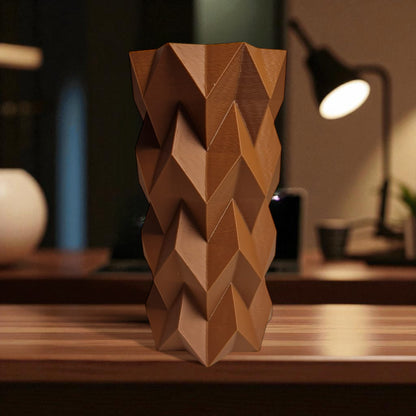 A modern 3D-printed vase with a sleek, sculptural design. Made from durable, waterproof material, this stylish vase is perfect for fresh flowers, dried arrangements, or as a standalone decor piece. Ideal for contemporary and minimalist interiors.