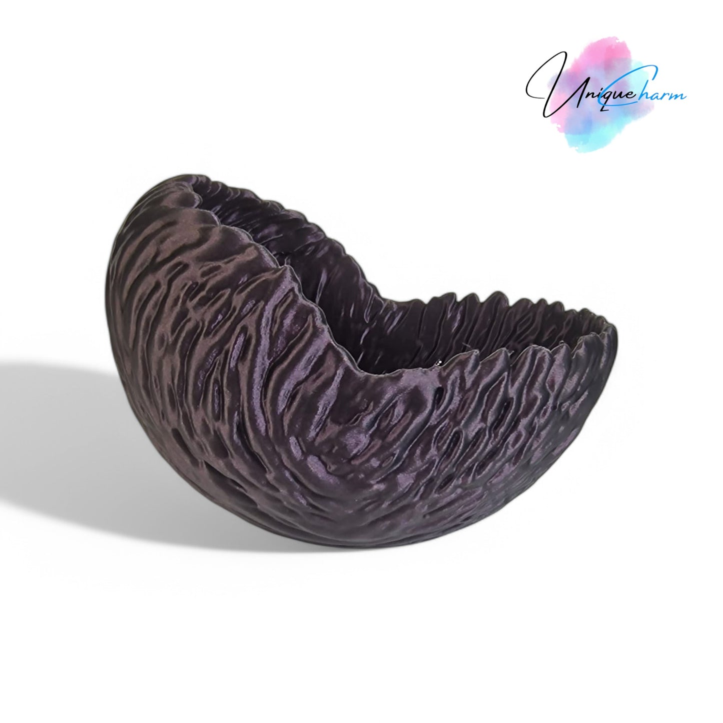 a beautifully designed walnut-shaped bowl resembling a quarter of a walnut shell, perfect as a key tray, candy dish, or nut bowl. features a rustic, nature-inspired design with a smooth finish, making it a stylish and functional home décor piece.