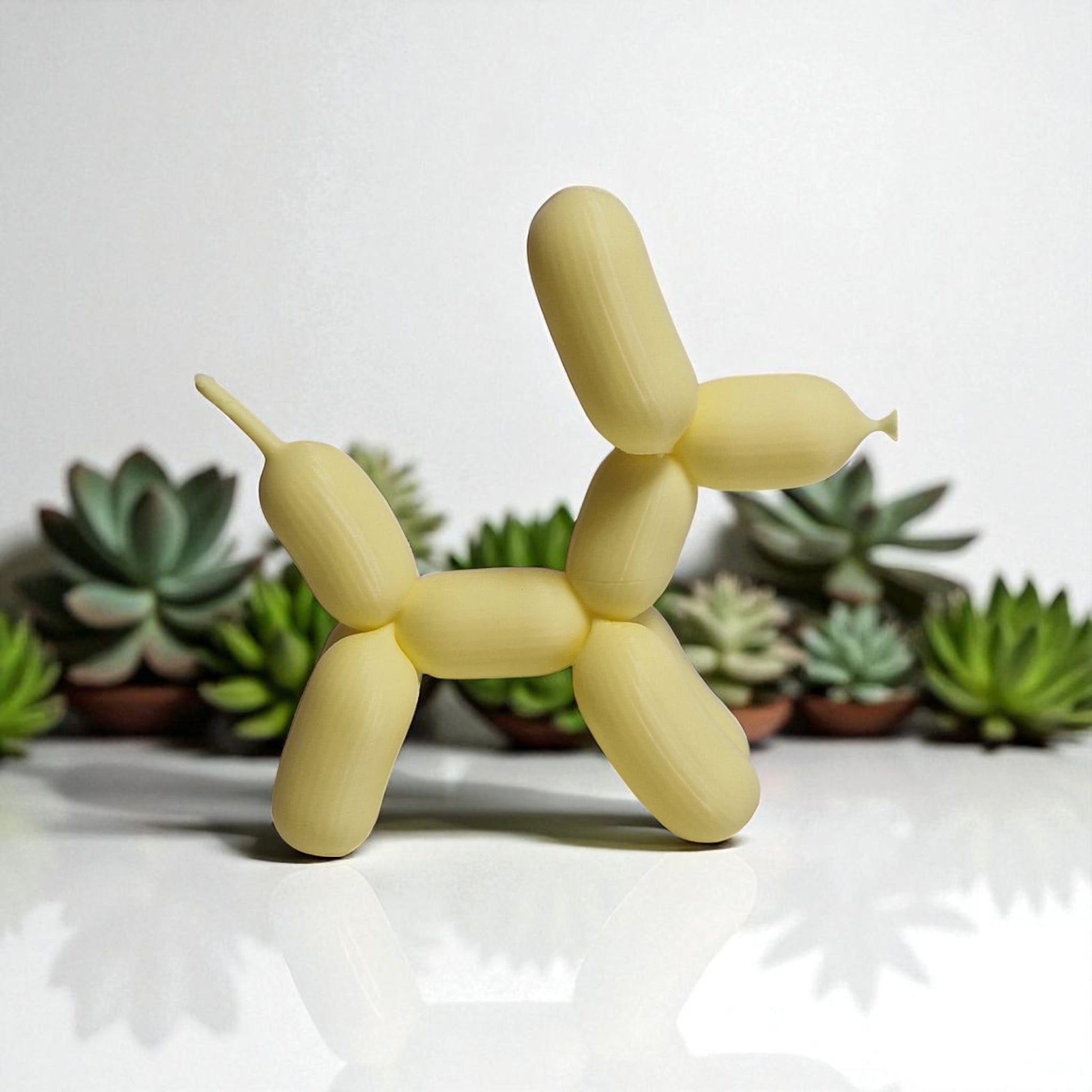 3D-printed figurine resembling a playful dog made from balloons, available in three different sizes. Perfect for home decor, kids' rooms, or as a unique gift for dog lovers.