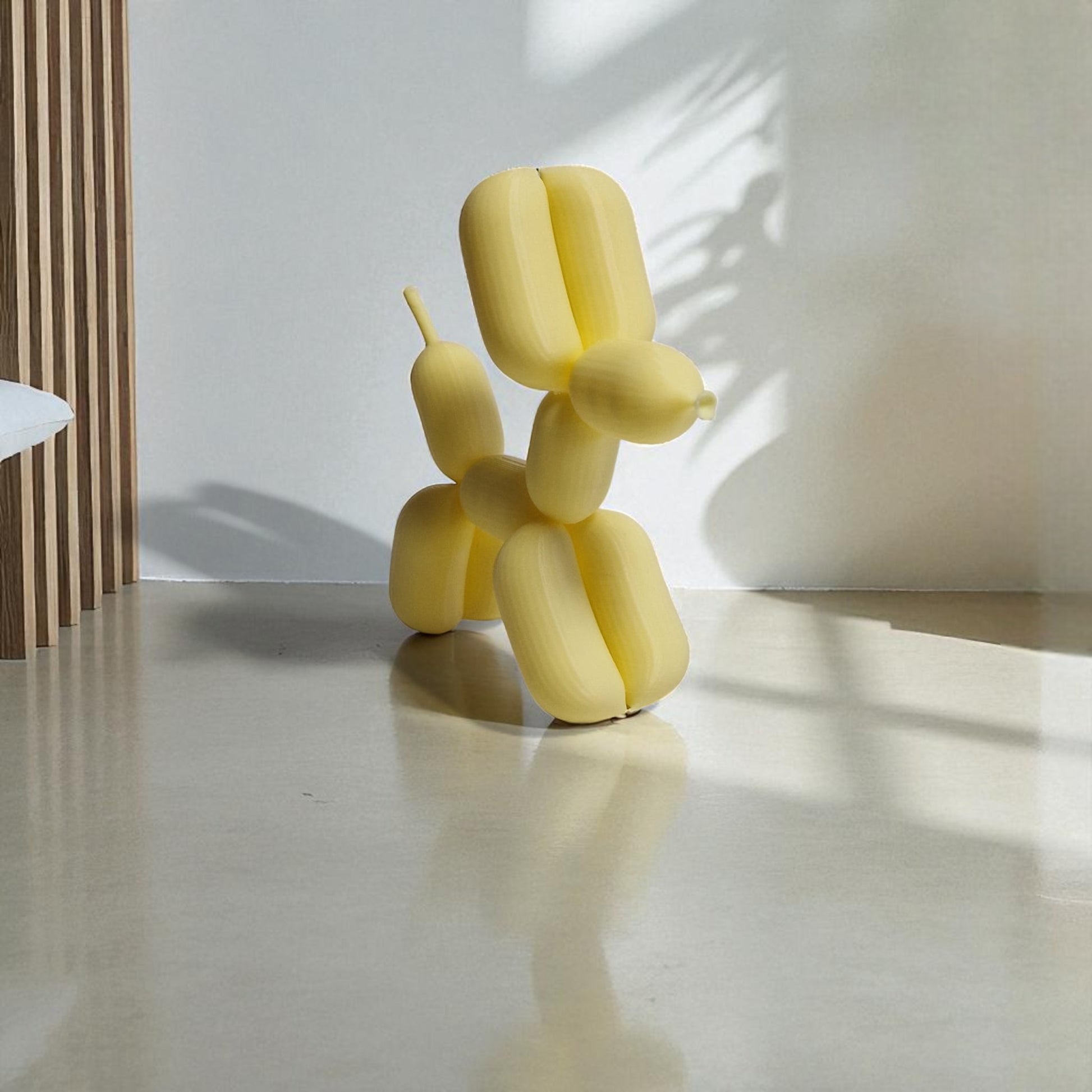 3D-printed figurine resembling a playful dog made from balloons, available in three different sizes. Perfect for home decor, kids' rooms, or as a unique gift for dog lovers.