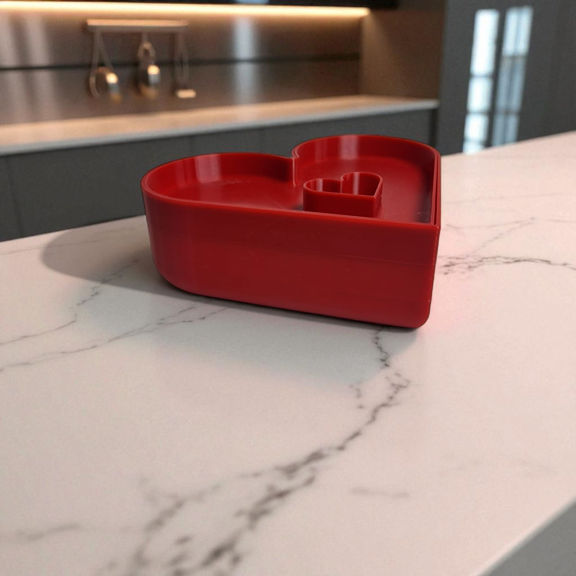 Red heart-shaped container on a marble countertop